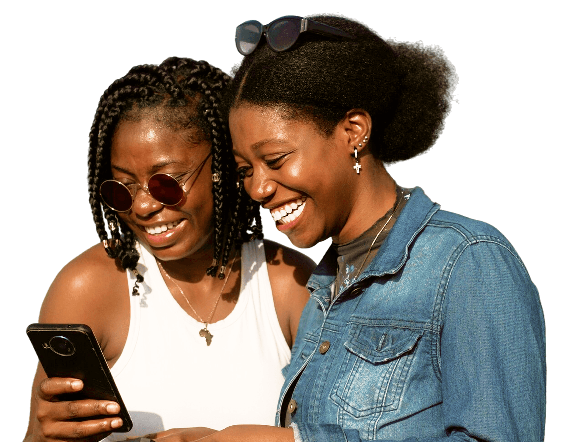 Two smiling Zambian women looking at a smartphone.